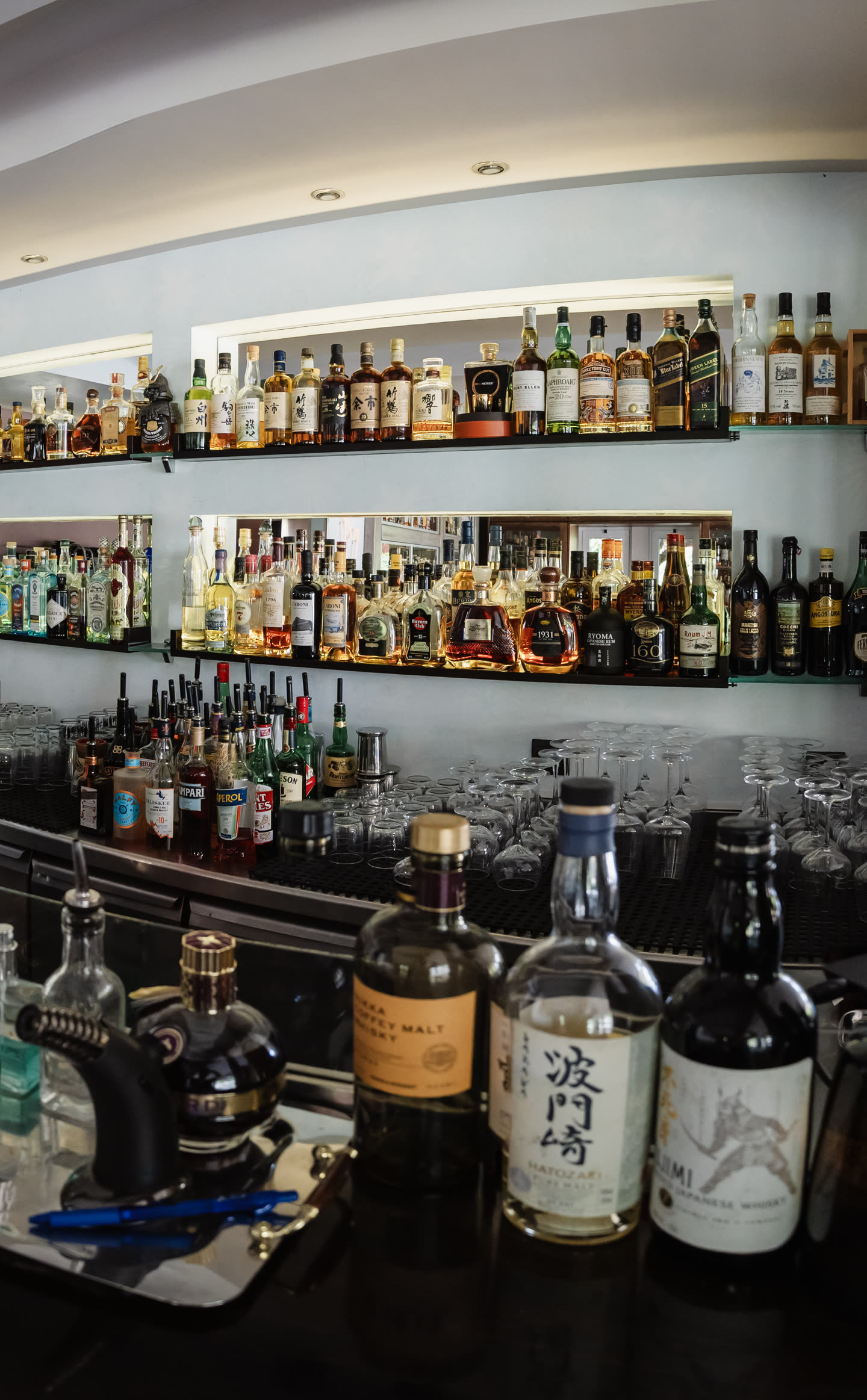 Floor-to-ceiling shelves of rare bottles behind the Madison bar