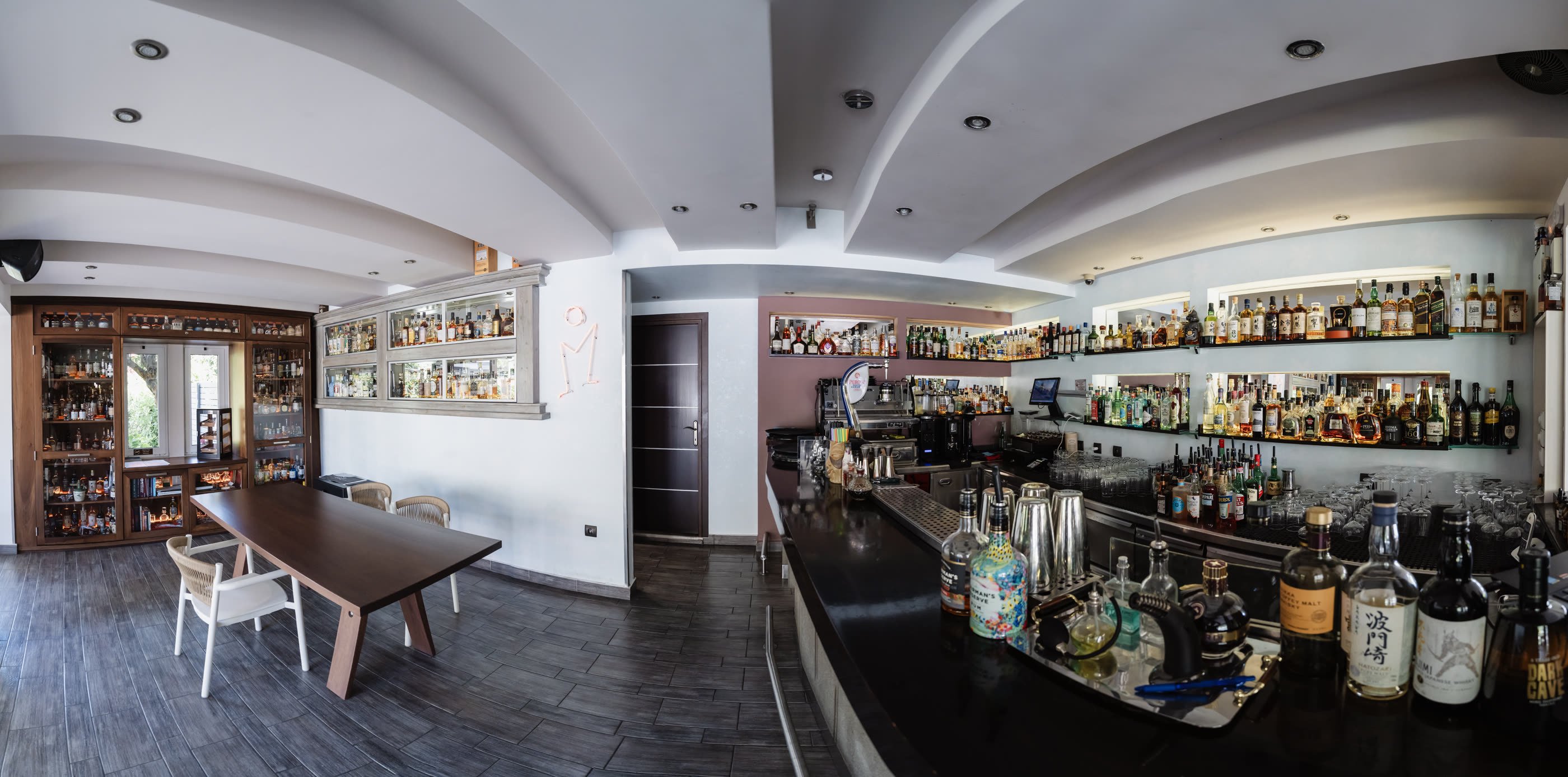 The Madison bar room in one sweep — the tasting table, the spirits library and the long counter