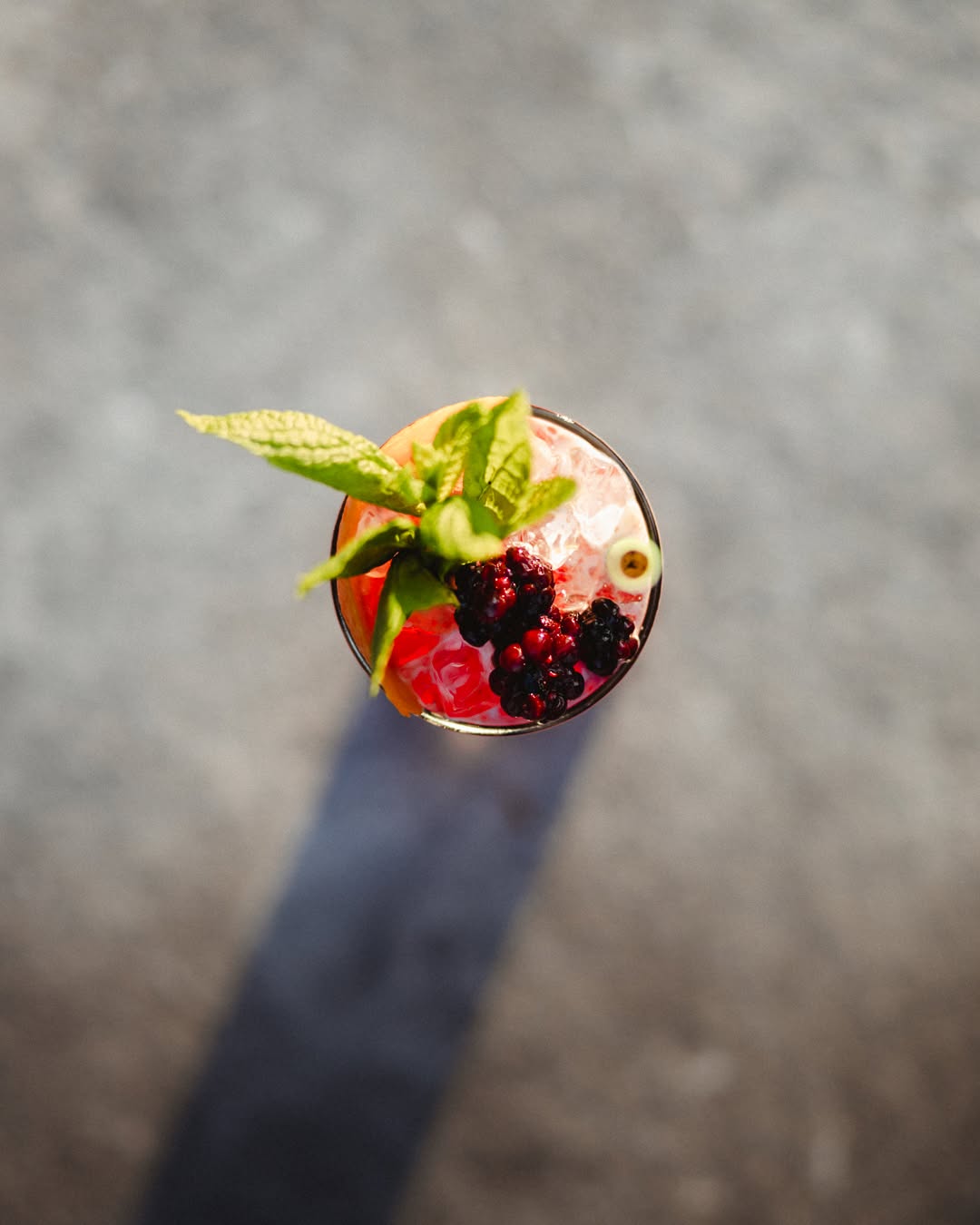 A berry cocktail from above, blackberries and verbena catching the evening sun