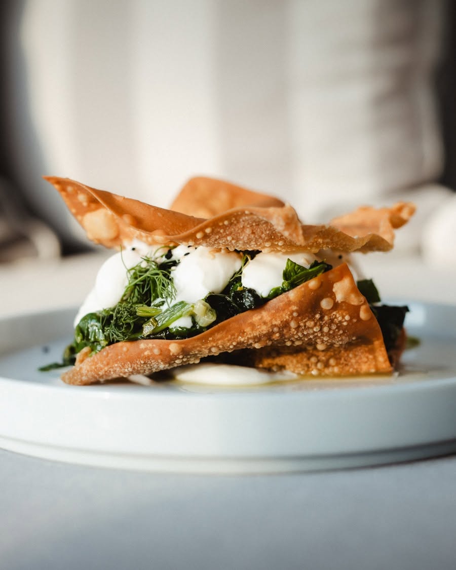 Crisp filo layered with greens and soft cheese on a pale plate